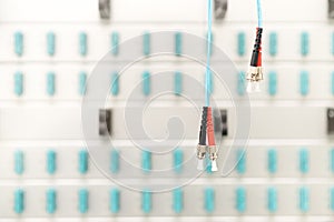 Fiber optic connectors with patch-panel on the background, server room, technology