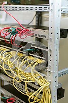 Fiber optic in server room close up. Many wires connect to the network interfaces of powerful Internet servers.  Children`s serve