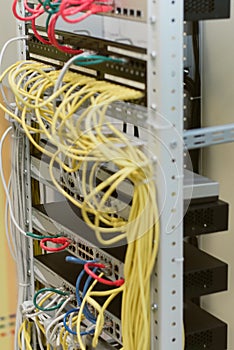 fiber optic in server room close up. Many wires connect to the network interfaces of powerful Internet servers. Children`s serve
