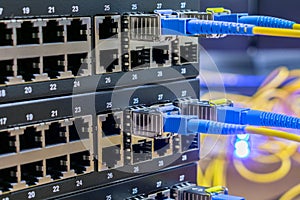 Fiber-optic wires are connected to the sfp module of the Internet switchboard. Server equipment of the telecommunications provider