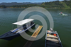 Fiber speed boat floating near the boathouse