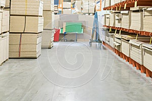 fiberboard and chipboard sheets on shelves in the building materials store. photo