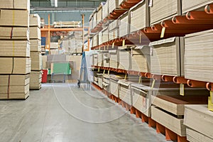 fiberboard and chipboard sheets on shelves in the building materials store. photo