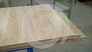 Woodworking industry and furniture assembly concept. Fiberboard at a furniture factory. Boards at the factory close-up. Fragment