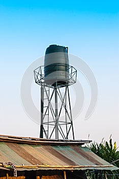 Fiberglass Water Tank Tower in Construction Site Slum of Thailand