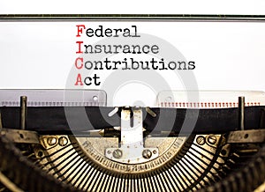 FICA symbol. Concept words FICA federal insurance contributions act typed on retro typewriter on beautiful white background.
