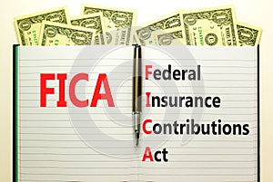 FICA symbol. Concept words FICA federal insurance contributions act on white note on beautiful white background. Dollar bills.