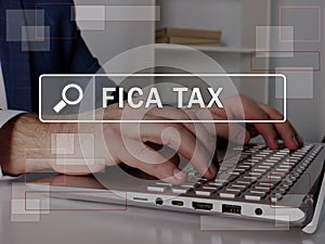 FICA TAX Federal Insurance Contributions Act text in search line. Broker looking for something at computer. FICA TAX Federal photo