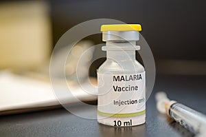 Malaria vaccine vial with a syringe photo