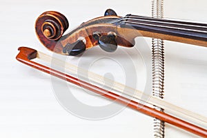 Fiddle bow and scroll on music book