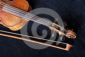 Fiddle pegbox and bow on black velvet photo