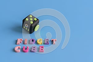 Fidget Cube stress reliever, Fingers Toy on a blue background