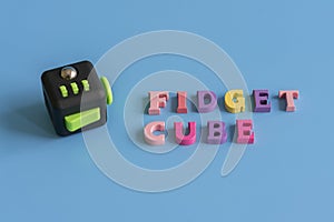 Fidget Cube stress reliever, Fingers Toy on a blue background