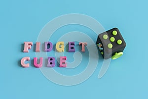 Fidget Cube stress reliever, Fingers Toy on a blue background