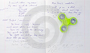 Fidget spinner stress relieving toy on notebook background