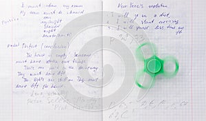 Fidget spinner stress relieving toy on notebook background