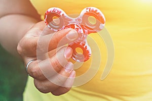 Fidget Spinner toy in girl hand, stress relieving toy