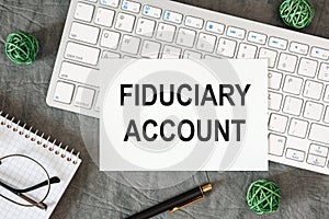 Fiduciary Account is written in a document on the office desk