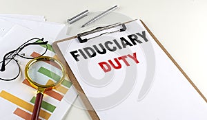 FIDUCIARY DUTY text on clipboard on white background, business concept