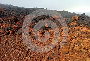 Field of aa lava rock, red and black volcanic clinkers in Piton de la fournaise, Reunion photo