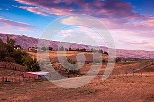 Field and Barn with Pink Clouds and Blue Sky