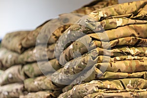 Field camouflage clothing on the shelf of a specialized warehouse-store for police and military uniforms