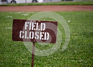 â€œField closedâ€ sign blocking access to a field in a park