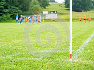 Field corner of outdoor football playground, football teams playing