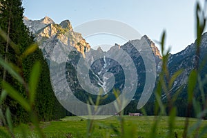 field and cottages under alpine panorama