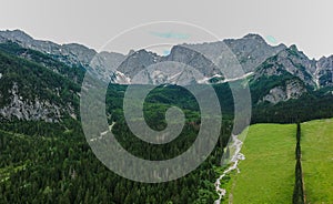 field and cottages under alpine panorama