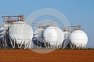 Field of crude oil tanks on agriculture field