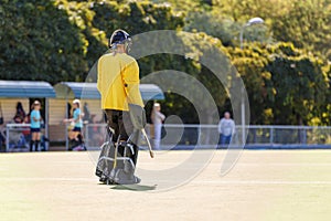 Field hockey female goalkeeper standing on field