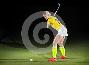 Field hockey girl player performing penalty stroke