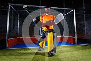 Field hockey goalie at the net ready to defense