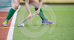 Field Hockey player, ready to pass the ball to a team mate. Hockey is a team game