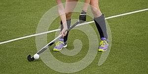 Field Hockey player, ready to pass the ball to a team mate. Hockey is a team game