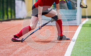 Field Hockey player, ready to pass the ball to a team mate. Hockey is a team game