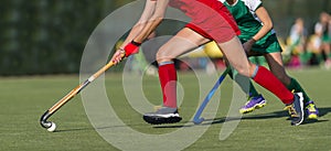 Field Hockey player, ready to pass the ball to a team mate. Hockey is a team sport