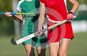 Field Hockey player, ready to pass the ball to a team mate. Team sport concept