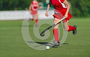 Field Hockey player, ready to pass the ball to a team. Woman team sport concept