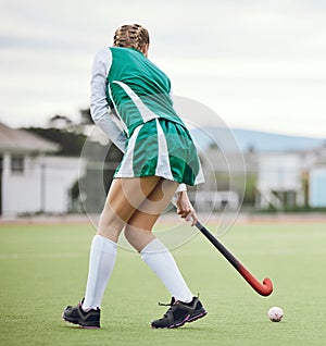 Field, hockey and woman running in game, tournament or competition with ball, stick and action on artificial grass