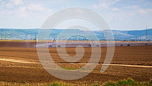 Field irrigation system. An irrigation pivot watering a field