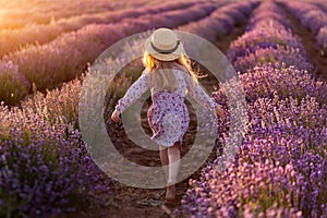 Lavender. A little girl in a hat run. Rear view.