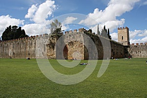 Field of Miracles Campo dei Miracoli next to the walls behind the Baptistery of St. John Battistero in Pisa, Tuscany, Italy