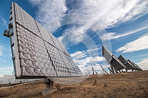 Field of photovoltaic solar panels gathering energy.