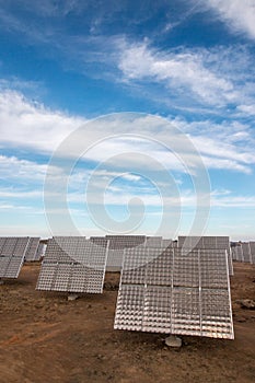 Field of photovoltaic solar panels gathering energy.