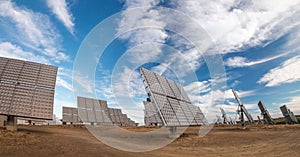 Field of photovoltaic solar panels gathering energy.