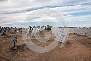 Field of photovoltaic solar panels gathering energy.