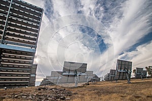 Field of photovoltaic solar panels gathering energy.