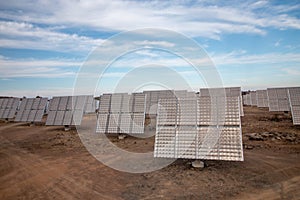 Field of photovoltaic solar panels gathering energy.